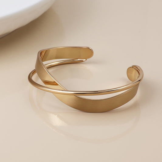 Golden brushed and smooth twist bangle