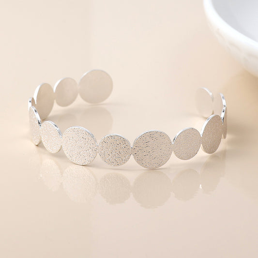 Silver plated dappled disc bangle