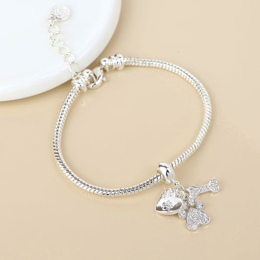 Silver plated crystal paw, bone and heart print charm bracelet