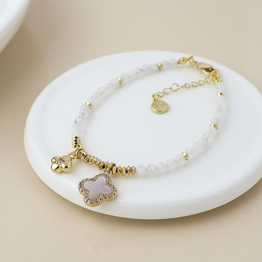 Golden and white bead quatrefoil charm bracelet