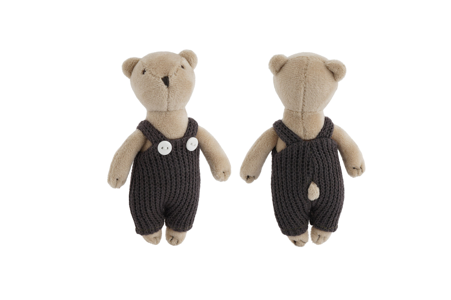 Teddy bears wearing dark knitted rompers on a white background