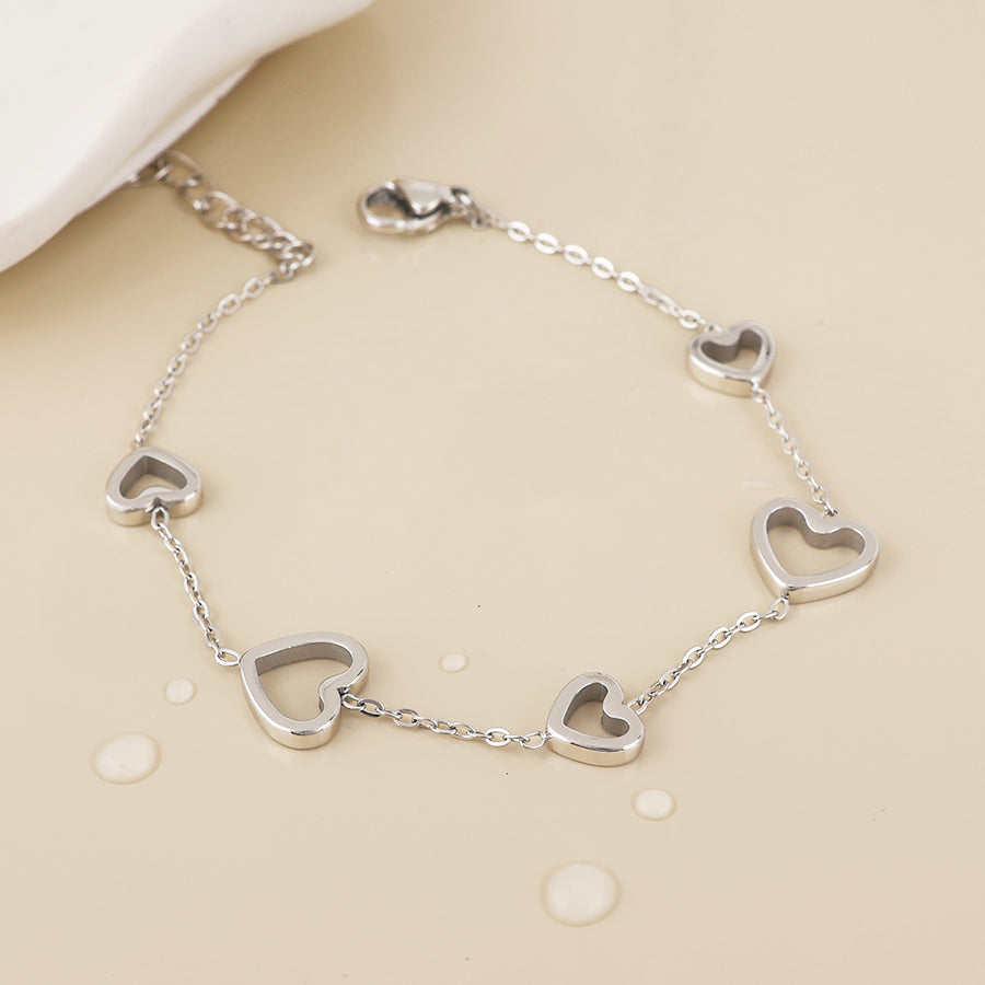 Cupid stainless steel platinum plated open hearts station bracelet