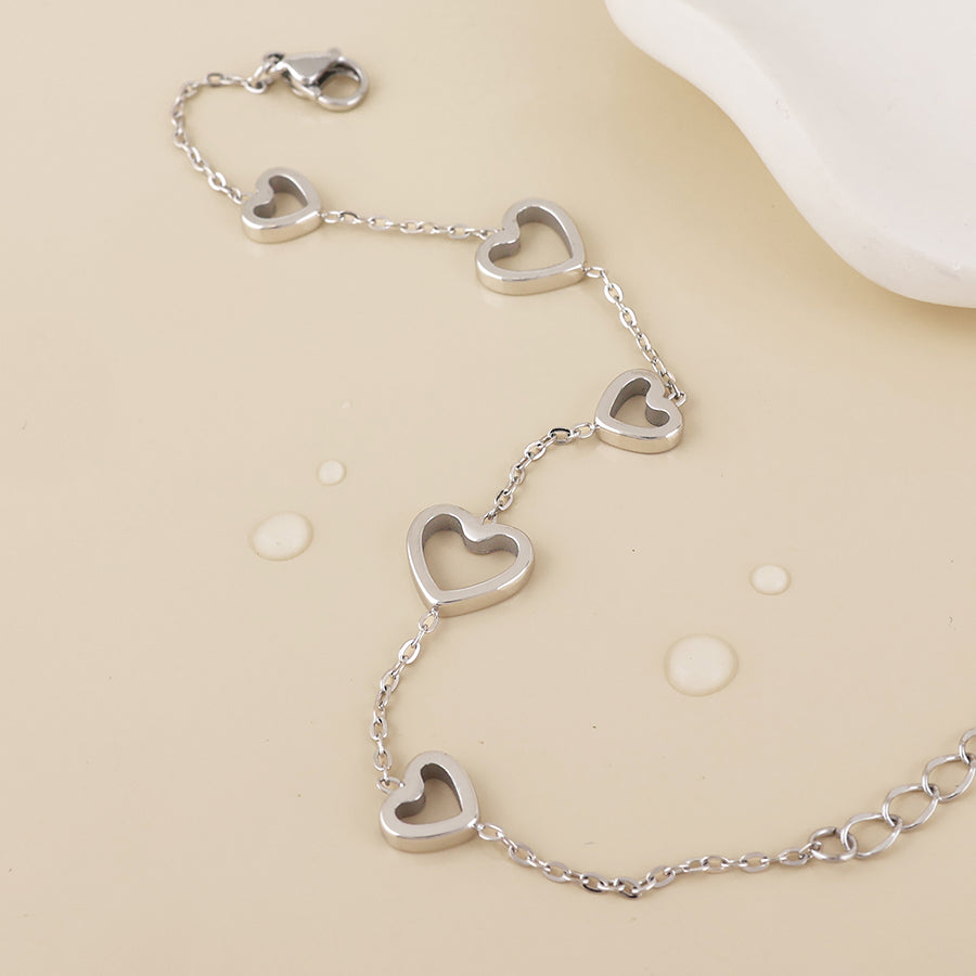Cupid stainless steel platinum plated open hearts station bracelet