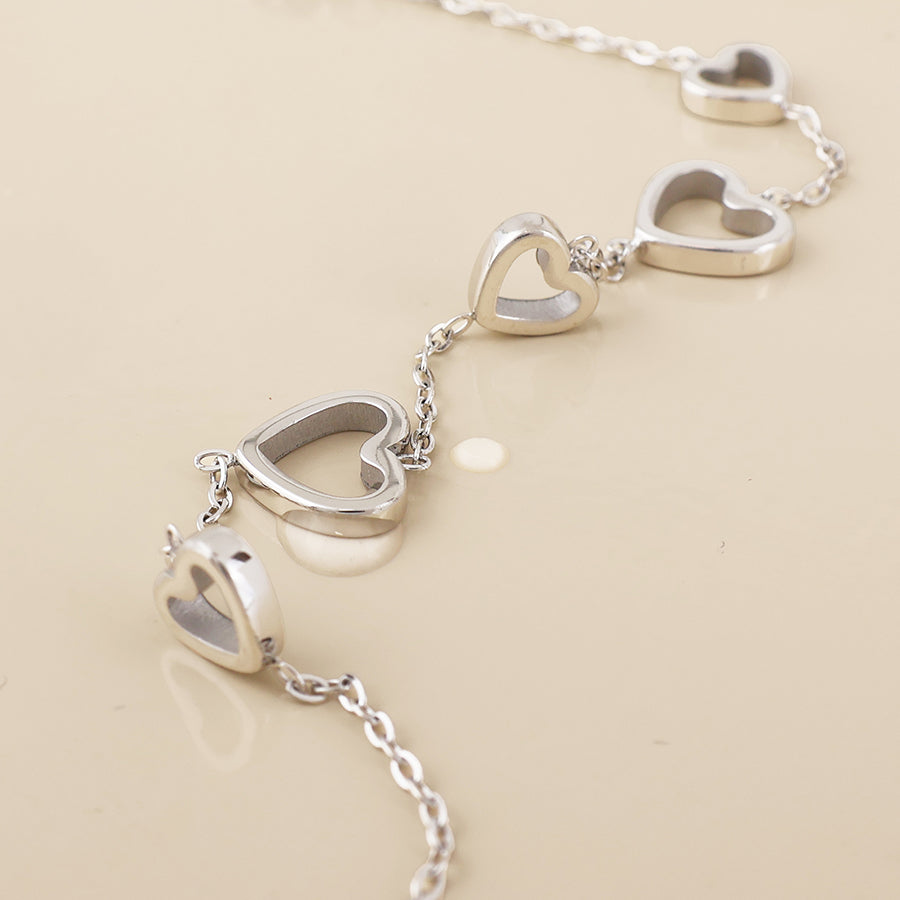 Cupid stainless steel platinum plated open hearts station bracelet